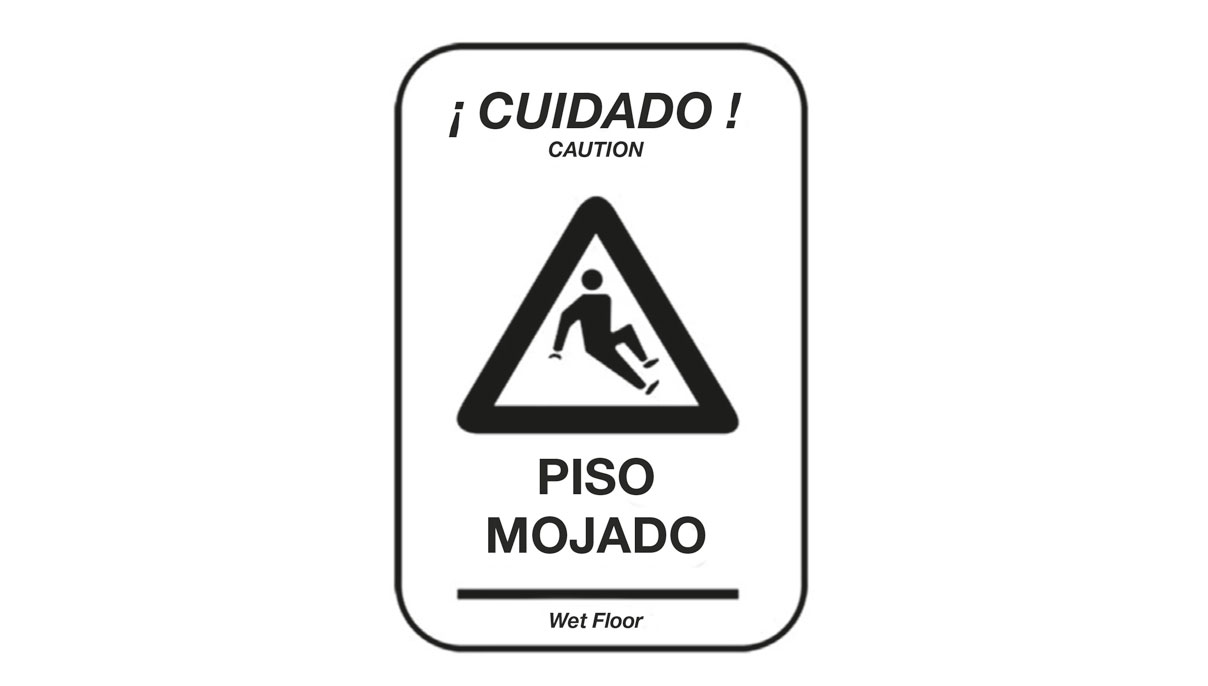 Imagen de un cartel con el texto cuidado! Piso mojado tanto en castellano como en inglés